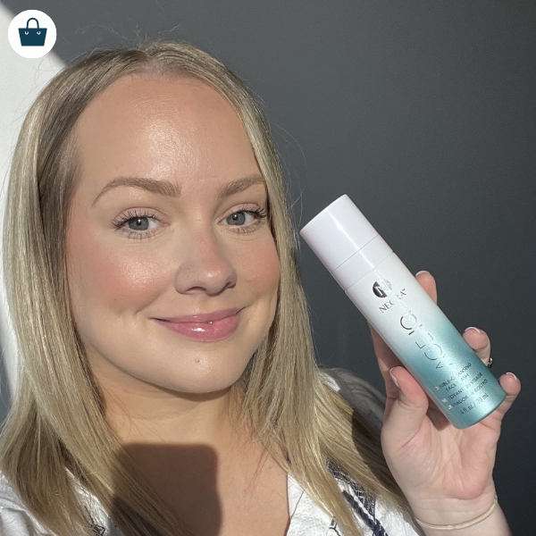 Woman smiling and holding Age IQ Double-Cleansing Face Wash 